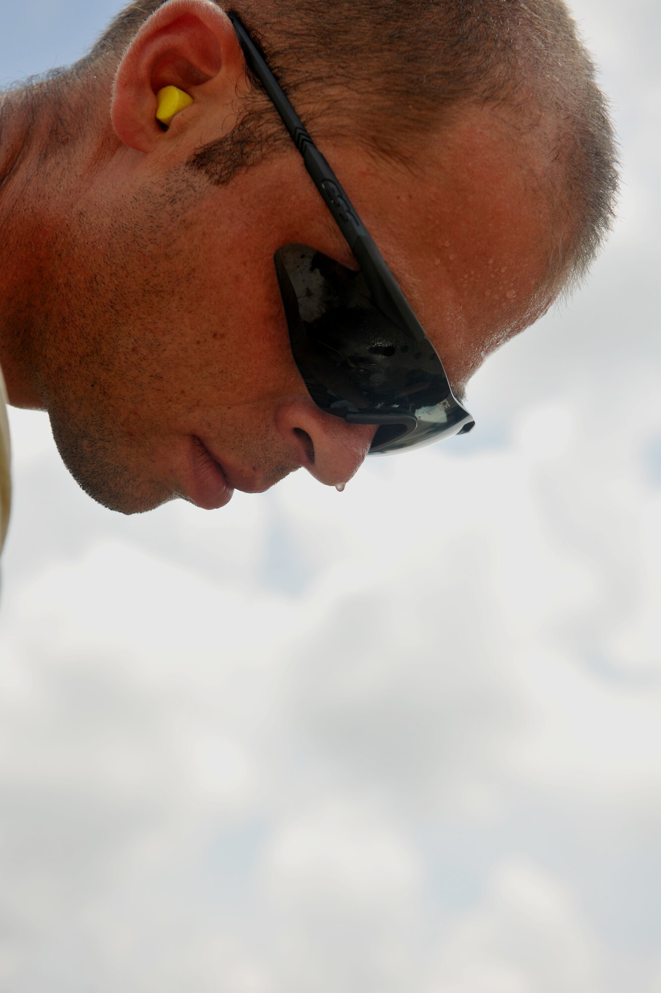 MOODY AIR FORCE BASE, Ga. -- Staff. Sgt. Matthew Chandler, 823rd RED HORSE Squadron engineering assistant, has sweat dripping down his face while using a core drill here July 15. Members of the 823rd RHS work six days a week in 100 degrees-plus temperatures on the flightline. (U.S. Air Force photo by Airman 1st Class Joshua Green/RELEASED)