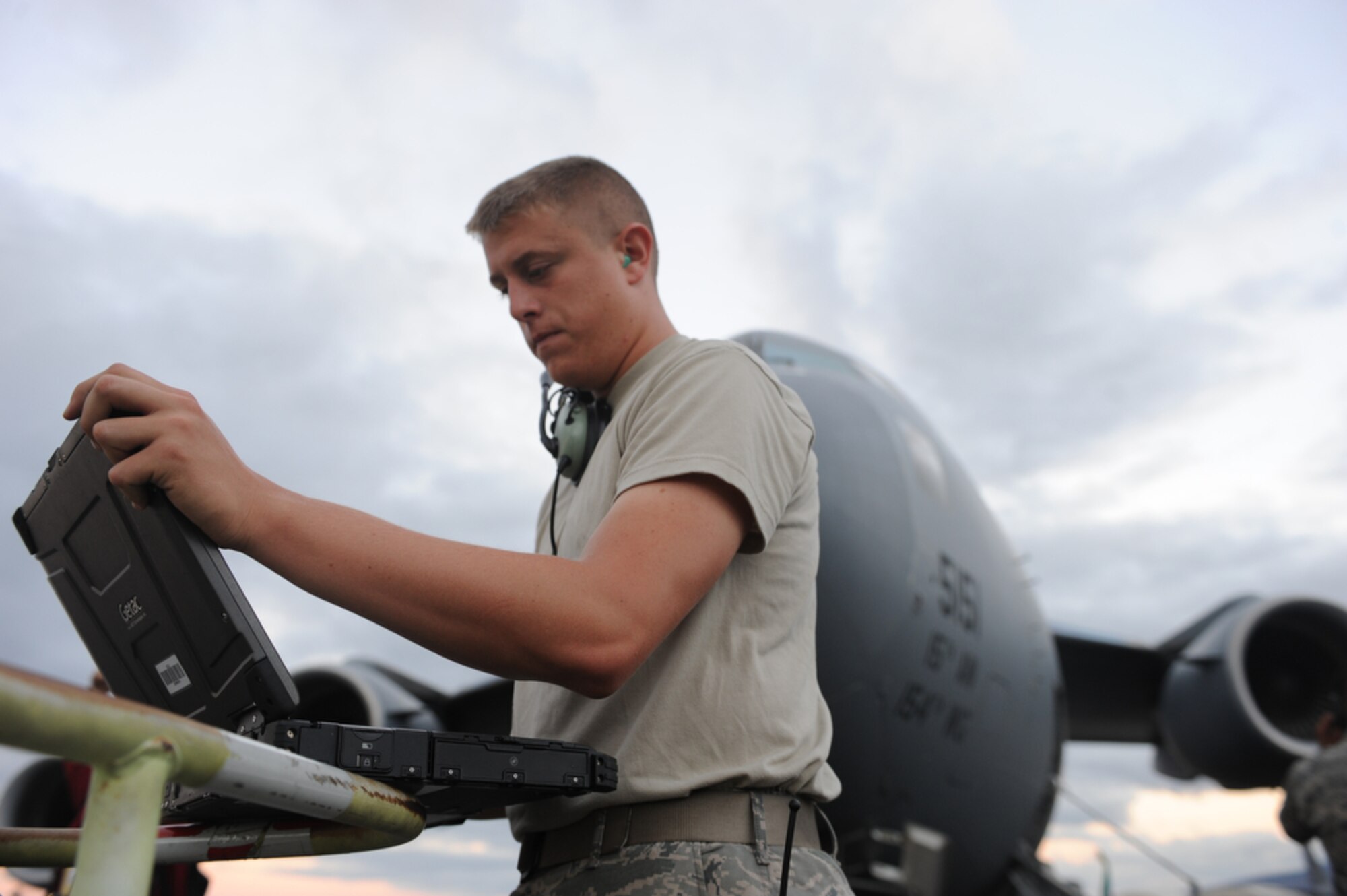 Airman First Class Thomas Thiessen verifies the engine performance of a  Globemaster III before the pilot takes off July 16, 2010 from Joint Base Pearl Harbor-Hickam, Hawaii. Airmen from the 535th Airlift Squadron performed an air drop as part of a demonstration to local Hawaiian bloggers that are viewing the capabilities of Pacific Air Forces for the first time. (U.S.  Air Force photo/Tech Sgt. Cohen A. Young)

