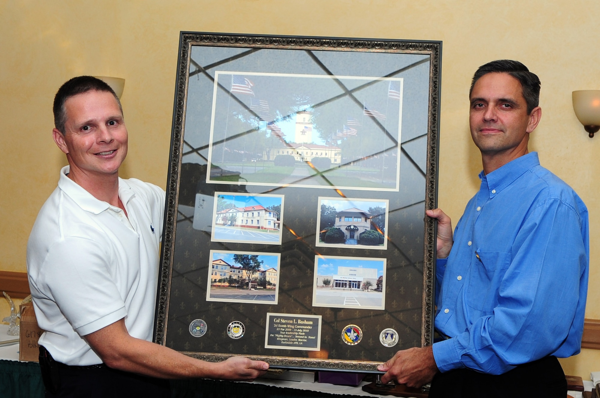 BARKSDALE AIR FORCE BASE, La. – Col. Thomas Hesterman, 2d Bomb Wing vice commander, presents Col. Steven Basham, outgoing 2d BW commander with a gift on behalf of the wing during Colonel Basham’s farewell banquet at the Barksdale Club July 16. Colonel Basham relinquished command of the wing to Col. Timothy Fay July 19. (U.S. Air Force photo by Senior Airman Joanna  M. Kresge)