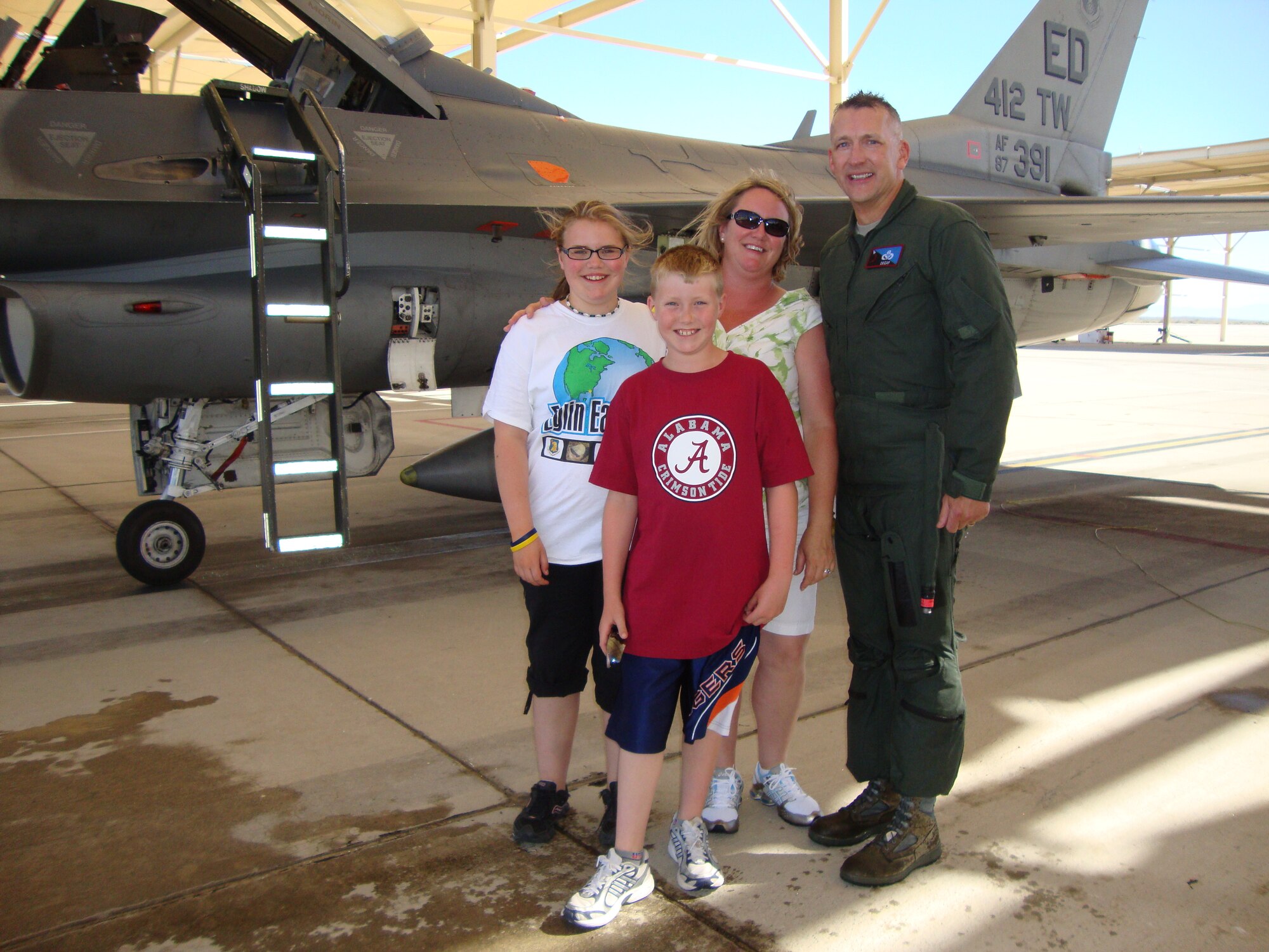 Chief Master Sgt. Mark S. Brejcha with his wife Kim and daughter and son, Katie and Jackson.  Chief Brejcha retires after nearly 30 years of active duty service.  (Air Force photo)