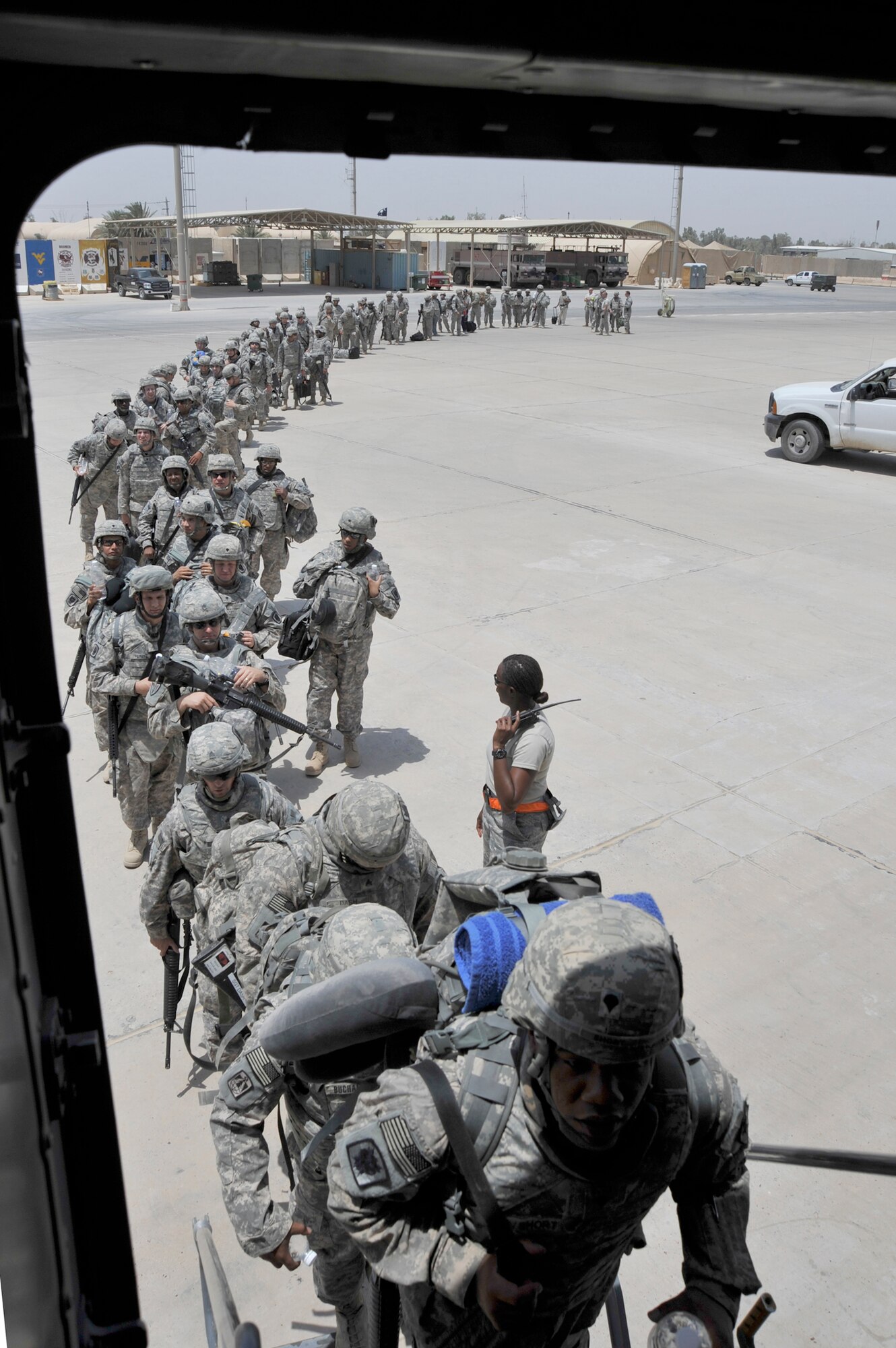 Members of Charlie Company, of the 67th Expeditionary Signal Battalion, board a C-17 Globemaster III July 10, 2010, at Sather AB, Iraq. Charlie Co. is redeploying to their home unit as part of the scheduled drawdown to 50,000 troops in Iraq by August 31, 2010. (U.S. Air Force photo/Senior Airman Perry Aston) 