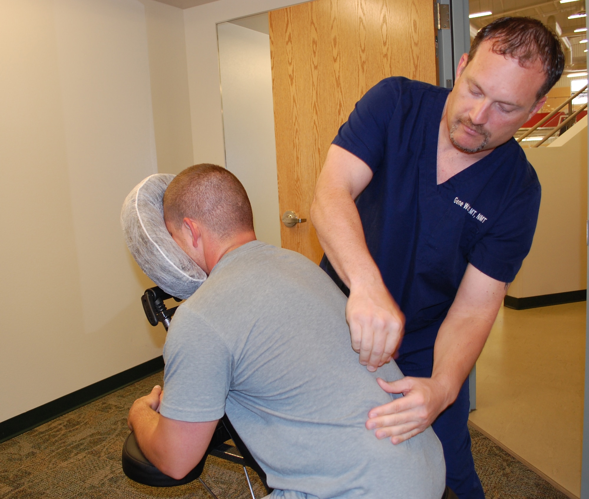 Licensed Massage Therapist Gene Watson performs a chair massage on Senior Airman Don Carr at the Fitness Center July 13. Chair massages can be purchase for $1 a minute for between five and 30 minutes. Airman Carr is a member of the 741st Missile Security Forces Squadron. (U.S. Air Force photo/Valerie Mullett)