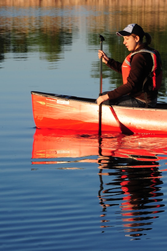 ELLSWORTH AIR FORCE BASE, S.D. -- Airman 1st Class Hayley Carlson, 28th Medical Operations Squadron occupational therapy technician, rows her canoe on Bandit Lake at Ellsworth Air Force Base, S.D., July 15.  When out on the water it's important to wear sun screen, due to the sun's rays reflecting off the water's surface. (U.S. Air Force photo/Airman 1st Class Anthony Sanchelli)