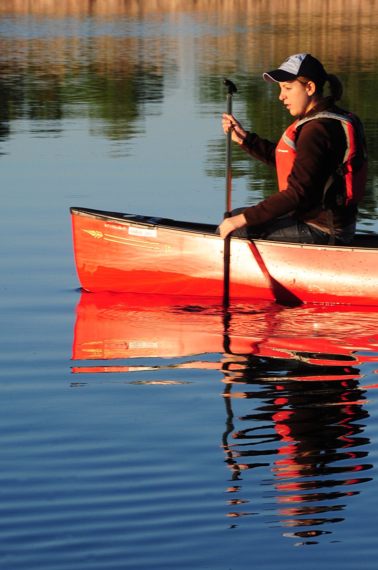 ELLSWORTH AIR FORCE BASE, S.D. -- Airman 1st Class Hayley Carlson, 28th Medical Operations Squadron occupational therapy technician, rows her canoe on Bandit Lake at Ellsworth Air Force Base, S.D., July 15.  When out on the water it's important to wear sun screen, due to the sun's rays reflecting off the water's surface. (U.S. Air Force photo/Airman 1st Class Anthony Sanchelli)