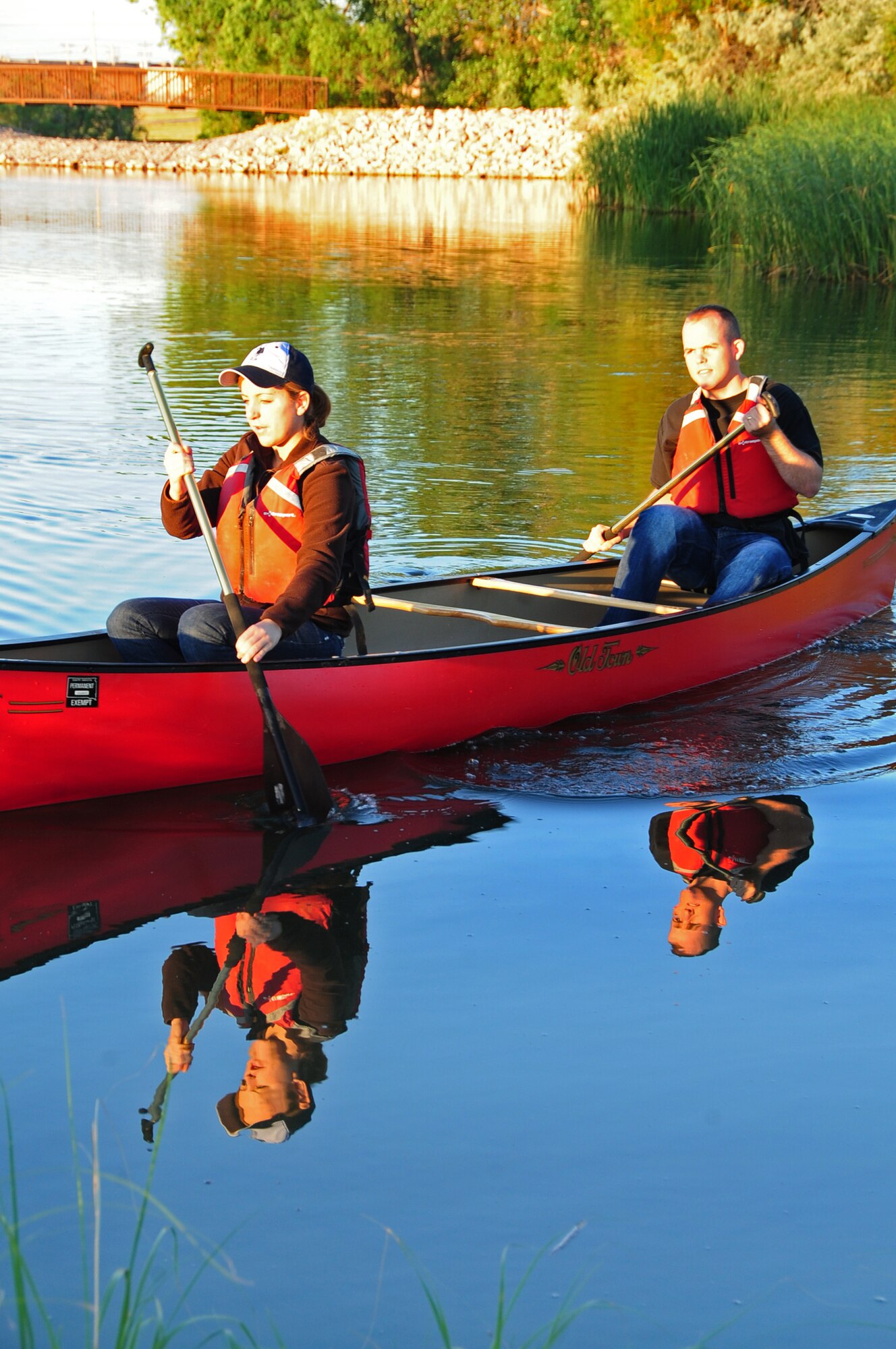 ELLSWORTH AIR FORCE BASE, S.D. -- (Left to right) Airmen 1st Class Hayley Carlson, 28th Medical Operations Squadron occupational therapy technician and Corey Hook, 28th Bomb Wing photographer, row their canoe towards shore on Bandit Lake at Ellsworth Air Force Base, S.D., July 15.  When out on a boat there must be a life-jacket for every passenger. (U.S. Air Force photo/Airman 1st Class Anthony Sanchelli)
