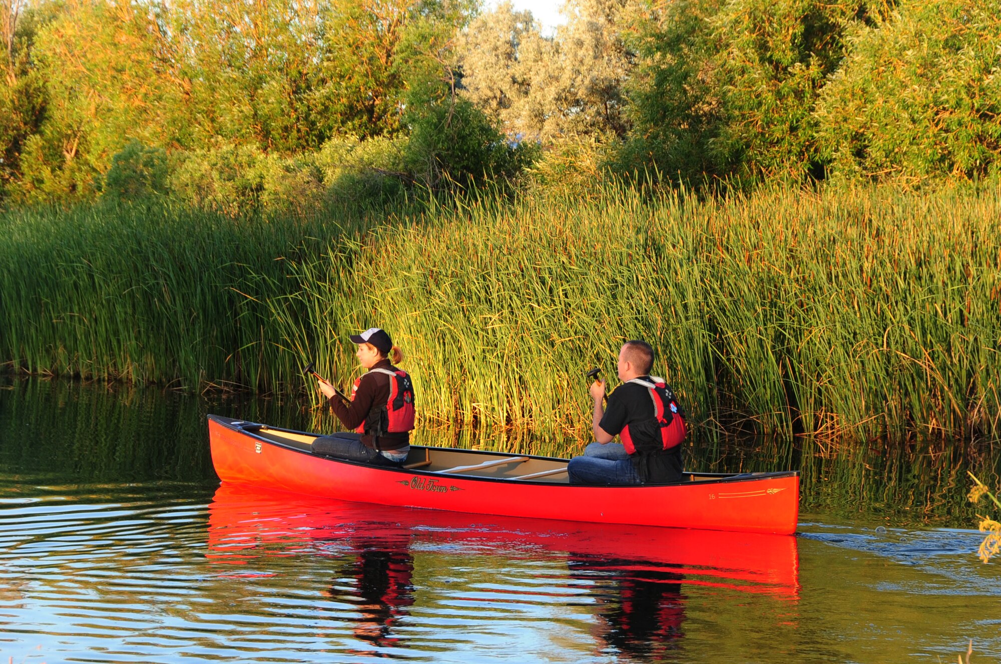 ELLSWORTH AIR FORCE BASE, S.D. -- (Left to right) Airmen 1st Class Hayley Carlson, 28th Medical Operations Squadron occupational therapy technician and Corey Hook, 28th Bomb Wing photographer, row their canoe around Bandit Lake at Ellsworth Air Force Base, S.D., July 15.  Both Airmen enjoy the summer while being safe on the water. (U.S. Air Force photo/Airman 1st Class Anthony Sanchelli)