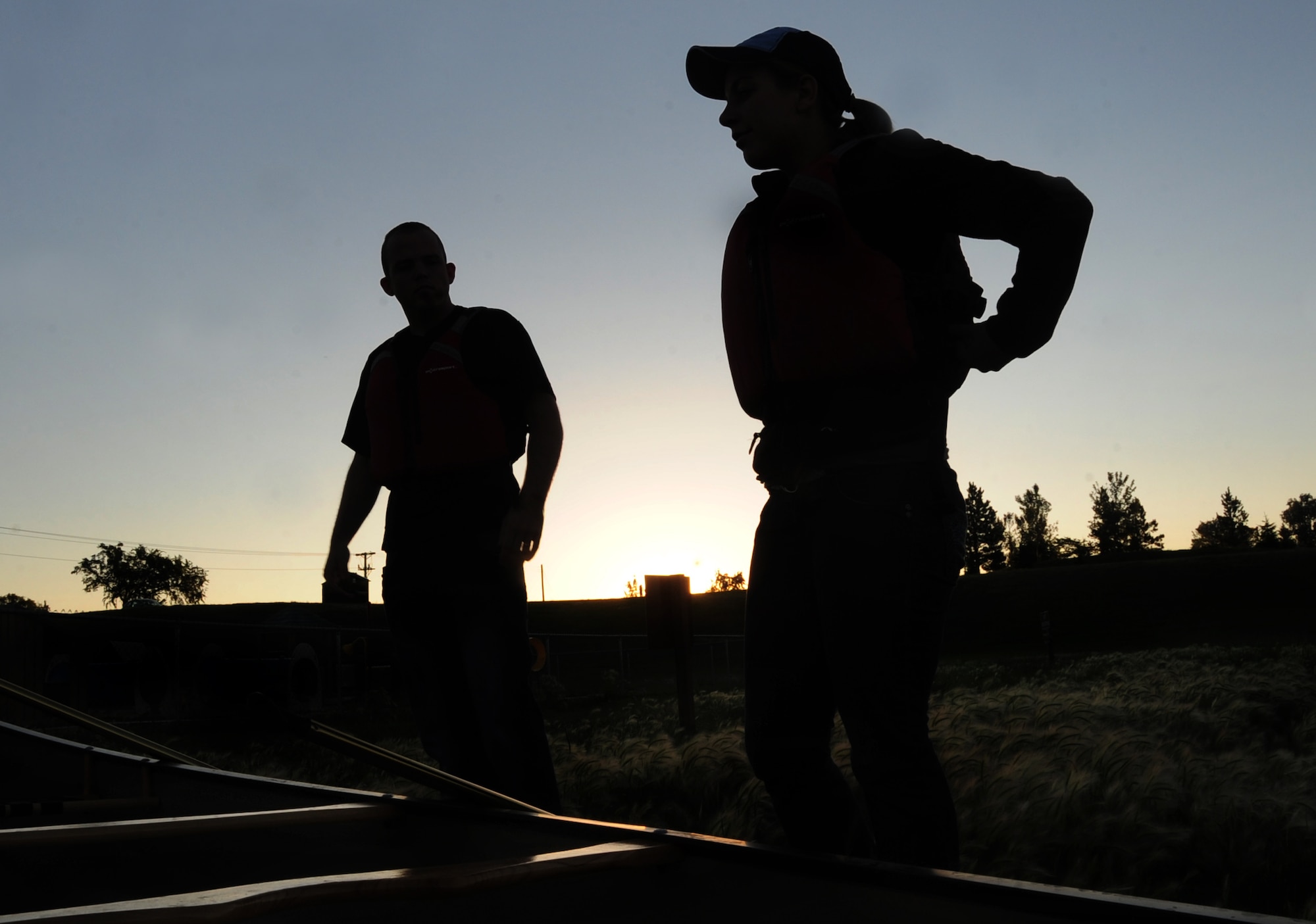 ELLSWORTH AIR FORCE BASE, S.D. -- (Right to left) Airmen 1st Class Hayley Carlson, 28th Medical Operations Squadron occupational therapy technician and Corey Hook, 28th Bomb Wing photographer, snap on all straps to their life-jackets before canoeing on Bandit Lake at Ellsworth Air Force Base, S.D., July 15.  Life-jackets are important, even for strong swimmers, in the case there is an accident and the wearer is knocked unconscious. (U.S. Air Force photo/Airman 1st Class Anthony Sanchelli)