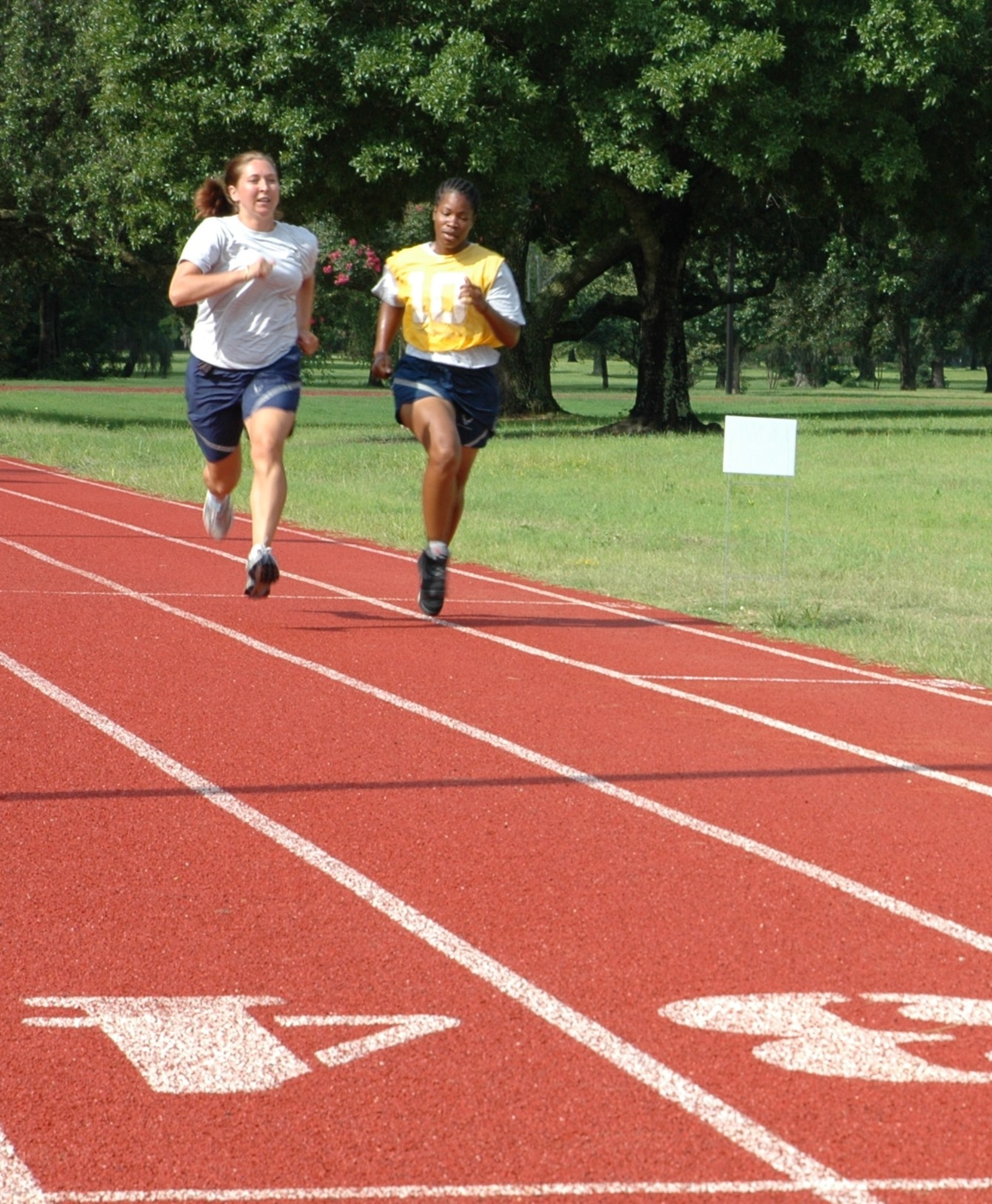 Maj. Christina Liegl, 315th Airlift Wing flight safety officer and fitness program manager, gives Staff Sgt. Calandra G. Cook a challenge to finish strong by running with her on the last lap of her bi-annual physical fitness test July 11, 2010 at the base running track here. Maj. Liegl is a 315 AW flight safety officer and fitness program manager Sergeant Cook is a supply technician with the 38th Aerial Port Squadron here. (U.S. Air Force photo/Staff Sgt. Shane Ellis)