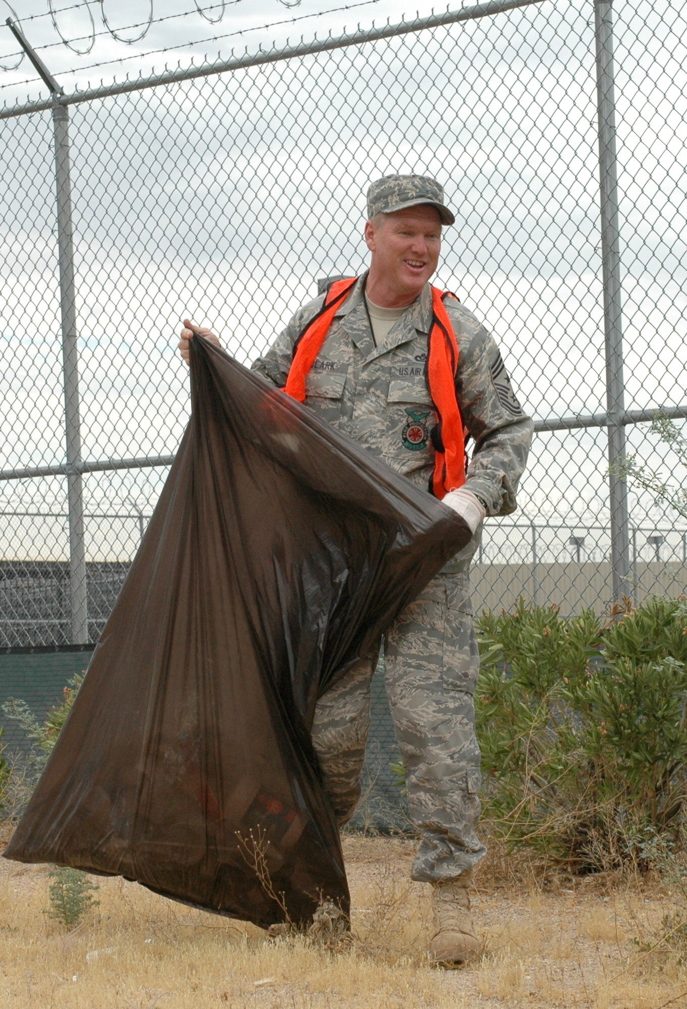 Command Chief Master Sgt. Shane Clark lends a hand to the 162nd Fighter Wing’s Junior Enlisted Council by picking up litter on Valencia Road. The council’s monthly “Adopt Valencia” cleanup effort ensures the base and surrounding community looks tidy. (Air Force by Master Sgt. Desiree Twombly)