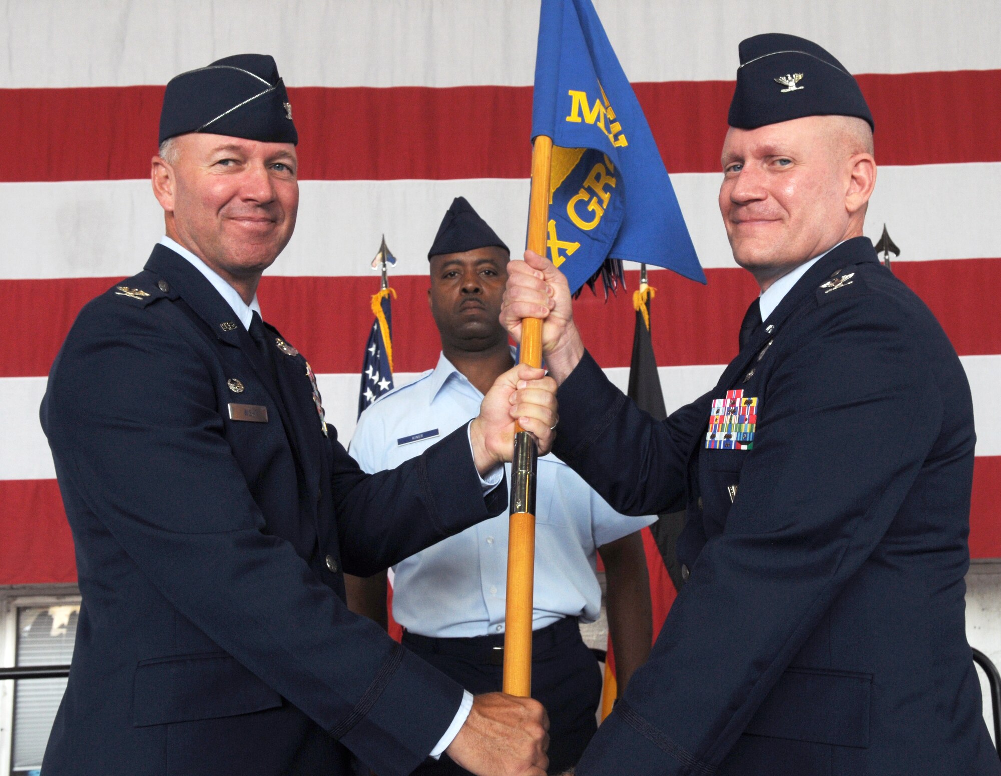 SPANGDAHLEM AIR BASE, Germany – Col. Duane Creamer, 52nd Maintenance Group commander, accepts command of the 52nd MXG by receiving the unit’s guidon from Col. Tip Wight, 52nd Fighter Wing commander, July 12. Colonel Creamer took command from Col. John Morley. (U.S. Air Force photo/Staff Sgt. Logan Tuttle)