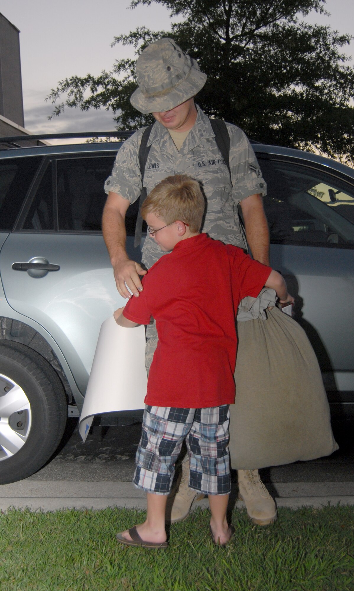 Airman 1st Class Joshua Lewis, 3rd Aerial Port Squadron, hugs his little brother after returning from a six-month deployment to Camp Bastion on July 14. Seven members of the 3rd APS returned to Pope after spending six months in Kandahar and Camp Bastion, Afghanistan. (U.S. Air Force photo/Senior Airman Kris Levasseur)