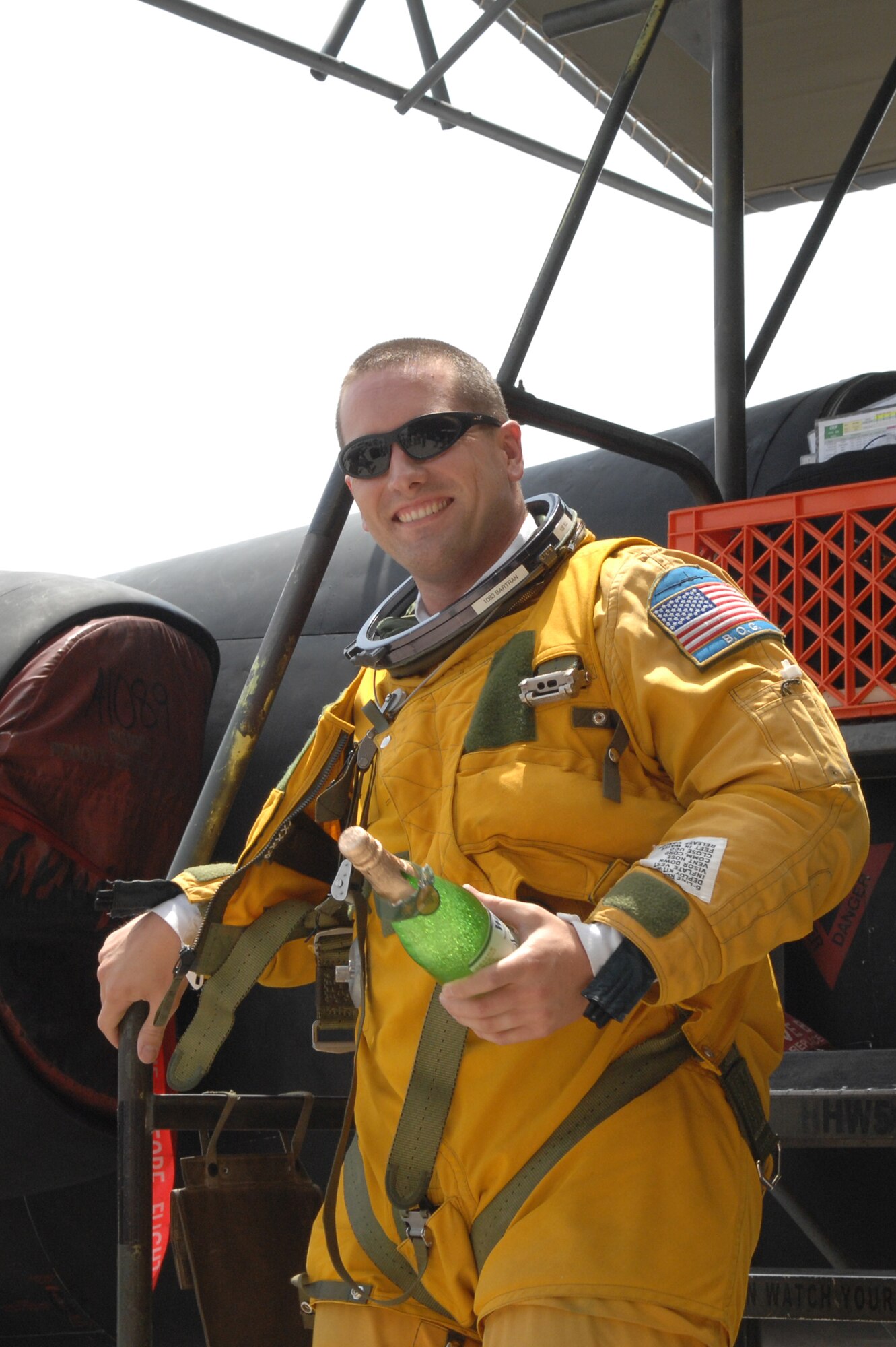 Capt. James Bartran, U2 Dragon Lady pilot, prepares to celebrate with sparkling grape juice after reaching his 1000th flying hour and 69th combat sortie in the U2 at an undisclosed location in Southwest Asia July 17. This is Captain Bartran’s seventh deployment piloting the Dragon Lady and the fifth flying with the 99th Expeditionary Reconnaissance Squadron. (U.S. Air Force photo/Tech.  Sgt. April Wickes)
