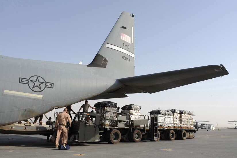A 451st Expeditionary Logistics Readiness Squadron 60K Tunner K-loader prepares to load a C-130J Hercules assigned to the 772nd Expeditionary Airlift Squadron with Low Velocity Low Cost Aerial Delivery System bundles July 16, 2010 at Kandahar Airfield, Afghanistan.  The airdrop bundles will be resupplying forward operating bases with food, water, and any required supplies needed to sustain the base.  (U.S. Air Force photo by Staff Sgt. Chad Chisholm/Released)