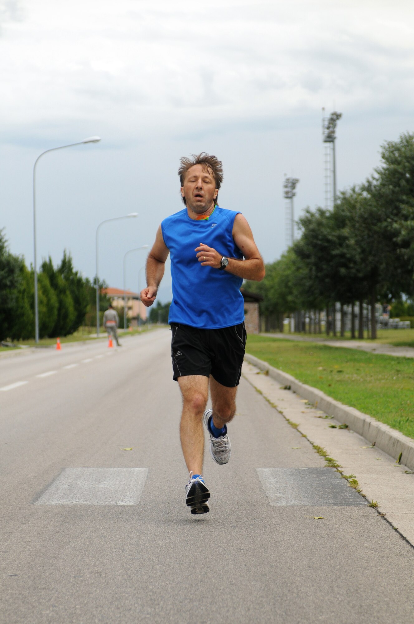 A racer runs during the Rosario Scarpolini Association's first memorial foot race July 18 on base. With the theme, "In the Airport...For a Little Solidarity Walk," the 5K and 9k races are part of a fundraising effort for the Rosario Scarpolini Association, an Italian organization that provides free furnished apartments to families of needy patients during care at the Center for National Cancer Institute in Aviano and at the Christmas Street. (U.S. Air Force photo/Staff Sgt. Julius Delos Reyes)