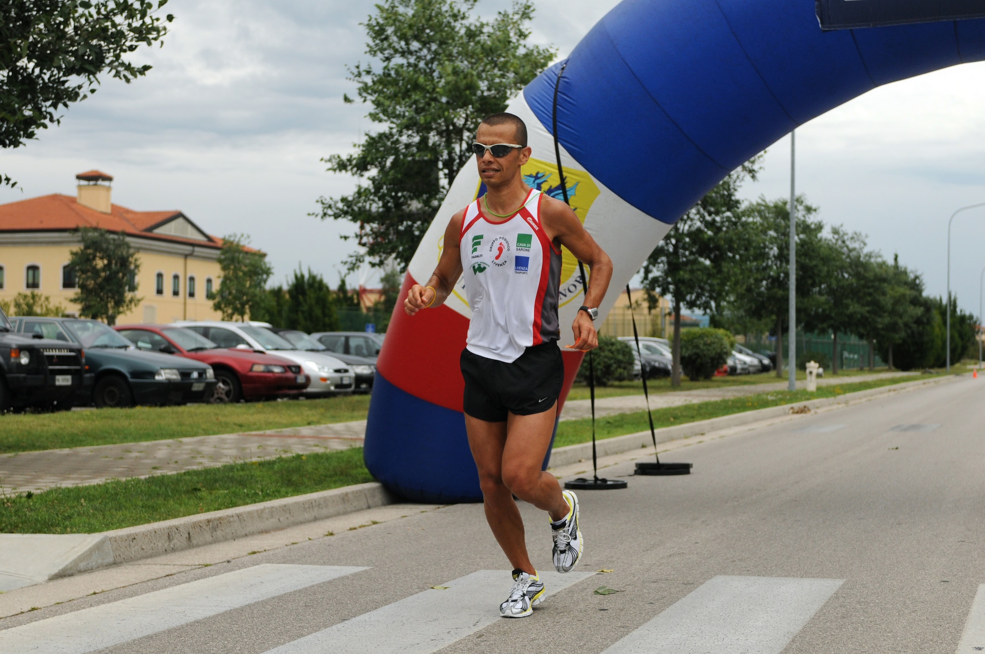 Giovanni Iommi runs during the Rosario Scarpolini Association's first memorial foot race July 18 on base. With the theme, "In the Airport...For a Little Solidarity Walk," the 5K and 9k races are part of a fundraising effort for the Rosario Scarpolini Association, an Italian organization that provides free furnished apartments to families of needy patients during care at the Center for National Cancer Institute in Aviano Italy. (U.S. Air Force photo/Staff Sgt. Julius Delos Reyes)