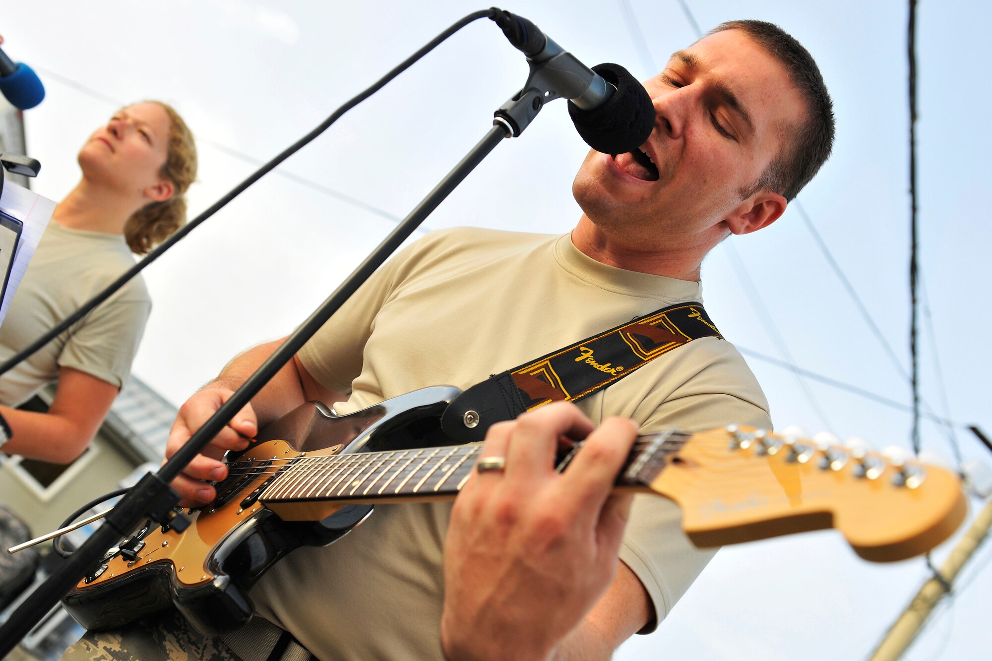 Staff Sgt. Brian McNally, High Altitude guitar player, sings for troops during a performance at the Base Exchange at Bagram Airfield, Afghanistan, July 14, 2010. The U.S. Air Forces Central Expeditionary Band is the first permanently assigned Air Force Band to the Central Command Area of Responsibility. (U.S. Air Force photo/Staff Sgt. Christopher Boitz)