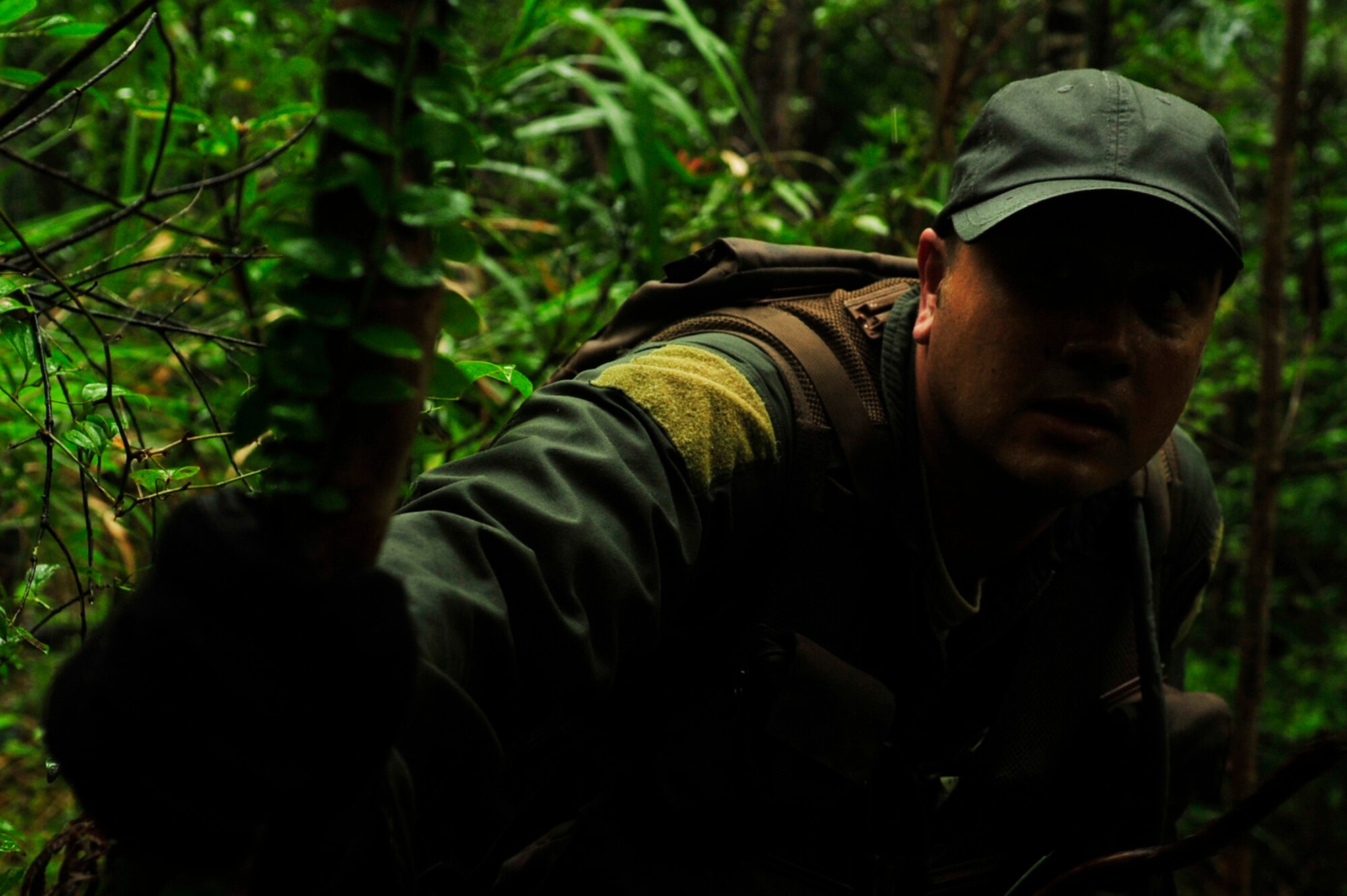 Master Sgt. John Matye, member of the 17th Special Operations Squadron, waits for the sign to move forward during a survival, evasion, resistance, and escape exercise at Kadena Air Base’s Area 1 July 1. Every three years aircrew members must undergo a refresher course of SERE training. (U.S. Air Force photo by Senior Airman Amanda Grabiec)