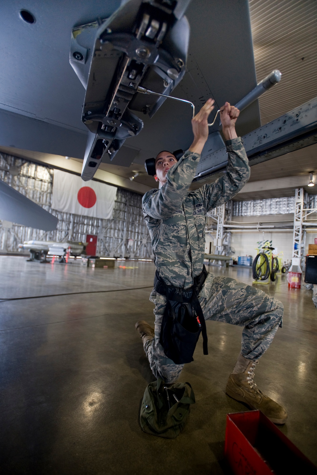 MISAWA AIR BASE, Japan -- Airman 1st Class Paul Callahan, 13th Aircraft Maintenance Unit weapons-load crew member, prepares an F-16 Fighting Falcon for ordnance during the weapons-load crew of the quarter competition July 16 at Hangar 911. Airman Callahan and his crew's score will compete against the 14th Aircraft Maintenance Unit currently deployed to Kunsan Air Base, South Korea. (U.S. Air Force photo/Senior Airman Jamal D. Sutter)