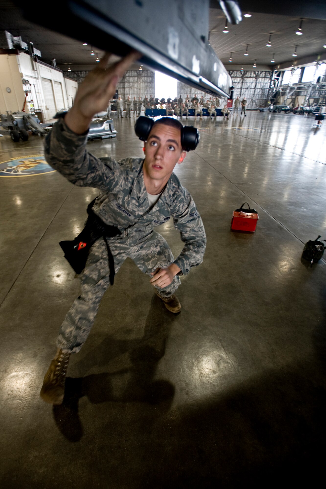 MISAWA AIR BASE, Japan -- Airman 1st Class Paul Callahan, 13th Aircraft Maintenance Unit weapons-load crew member, conducts final checks on an F-16 Fighting Falcon during the weapons-load crew of the quarter competition July 16 at Hangar 911. In addition to load time, the crew's total score consists of a weapons-knowledge test and a uniform inspection. (U.S. Air Force photo/Senior Airman Jamal D. Sutter)