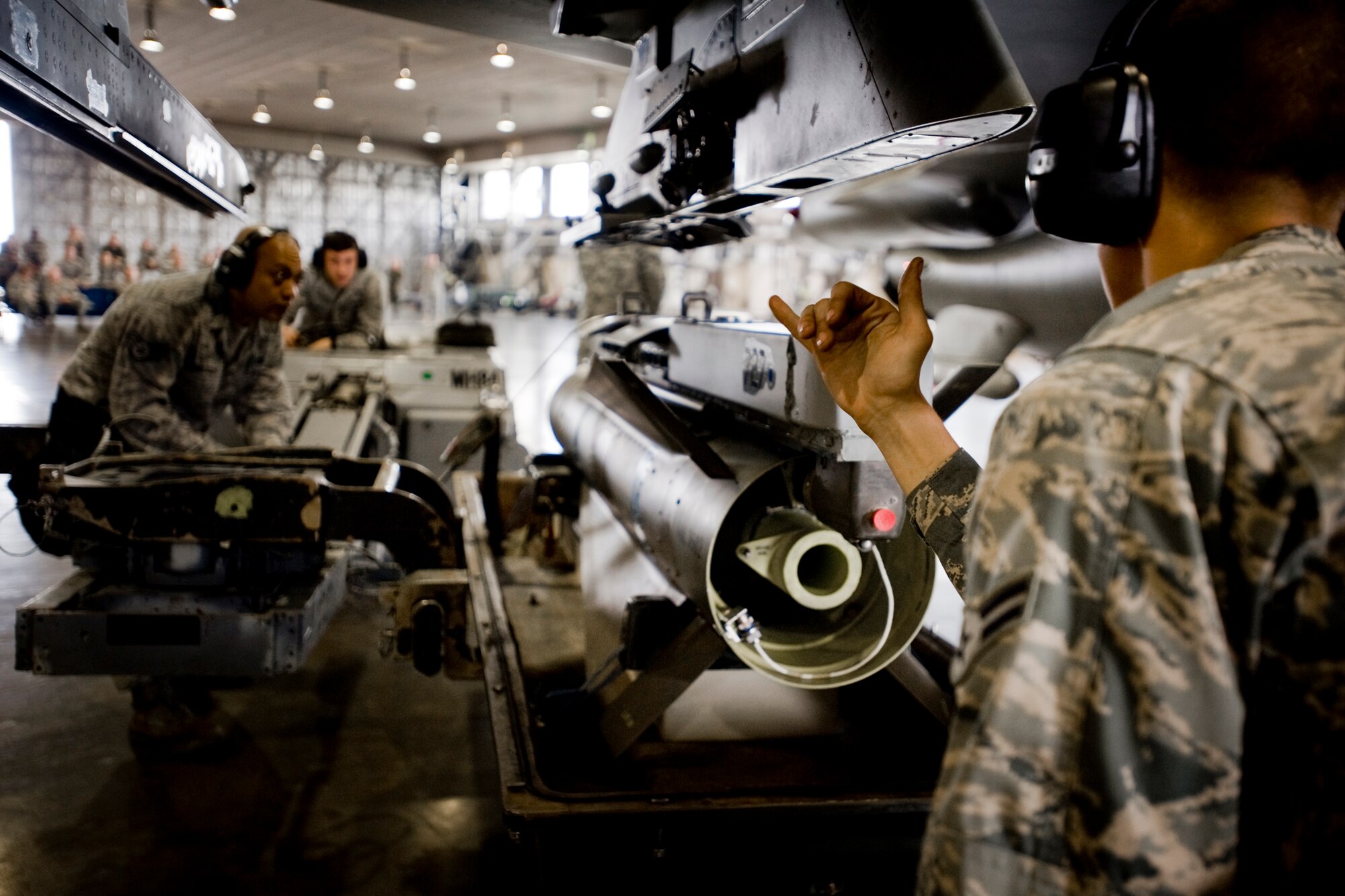 MISAWA AIR BASE, Japan -- Staff Sgt. Antonio Balayan, Airman 1st Class Paul Callahan and Airman Matthew Miller load an AGM-65D air-to-ground missile to an F-16 Fighting Falcon during the weapons-load crew of the quarter competition July 16 at Hangar 911. The crew finished with a final time of 12:47; the standard time for a similar load is approximately 20 minutes. (U.S. Air Force photo/Senior Airman Jamal D. Sutter)