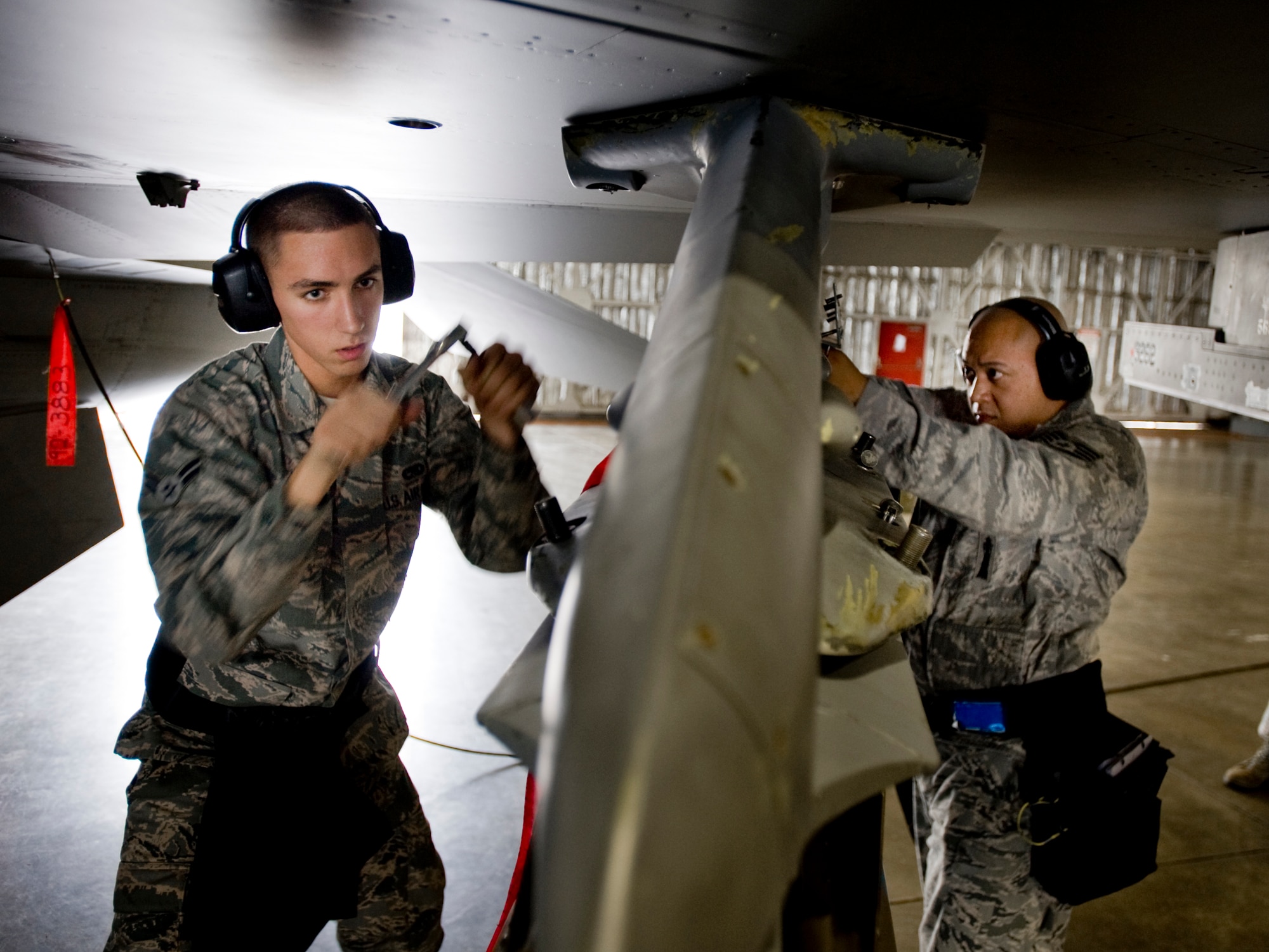 MISAWA AIR BASE, Japan -- Airman 1st Class Paul Callahan and Staff Sgt. Antonio Balayan, 13th Aircraft Maintenance Unit weapons-load crew members, secure an AGM-65D air-to-ground missile during the weapons-load crew of the quarter competition July 16 at Hangar 911. The competition will prove who is the 35th Fighter Wing's best load crew for the months of April through June. (U.S. Air Force photo/Senior Airman Jamal D. Sutter)