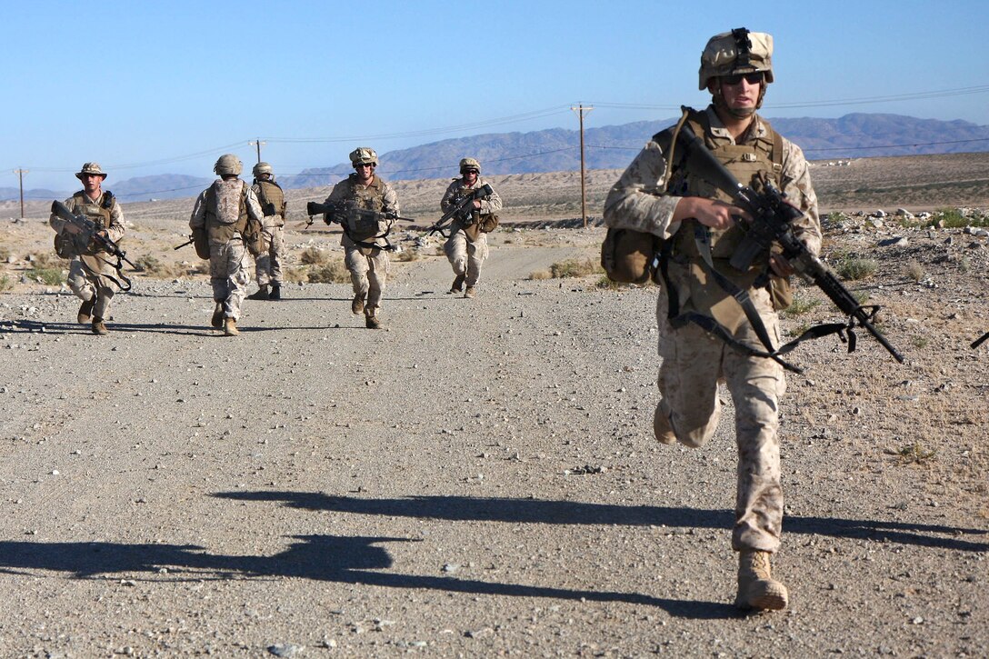 U.S. Marines perform maneuver-at-speed reloads during Enhanced Mojave Viper, a training exercise at range 107 on Marine Corps Base Twentynine Palms, Calif., July 7, 2010.
