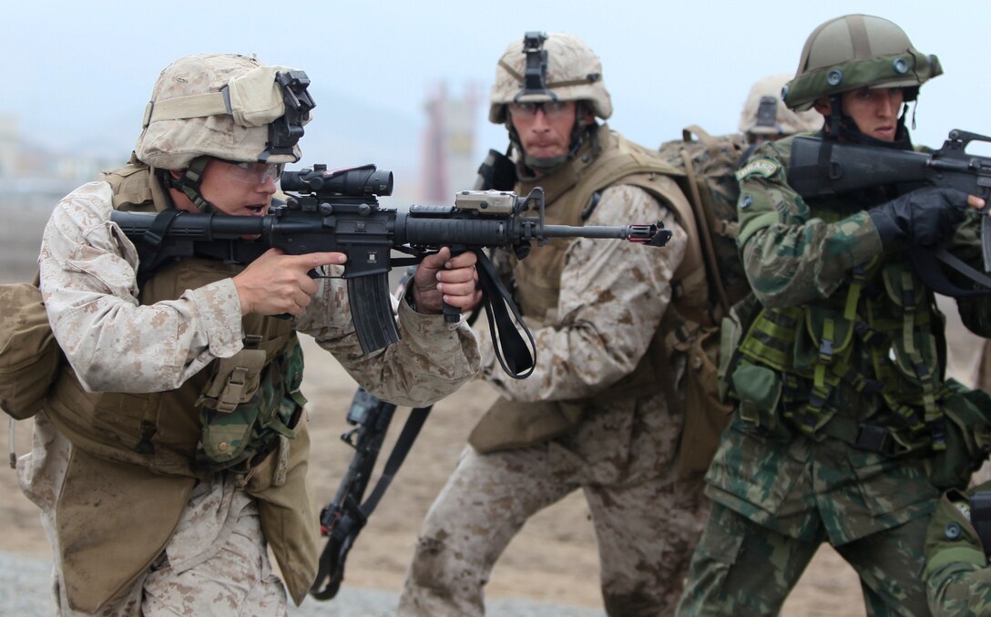 U.S. Marines with Special Purpose Marine Air-Ground Task Force 24 raid a building during multinational amphibious beach assault training exercise in Ancon, Peru on July 19, 2010 The unit was deployed in support of operation Partnership of the Americas/Southern Exchange, a combined amphibious exercise designed to enhance cooperative partnerships with maritime forces from Argentina, Mexico, Peru, Brazil, Uruguay, and Colombia.   (U.S. Marine Photo photo by Cpl Brian J. Slaght/Released)