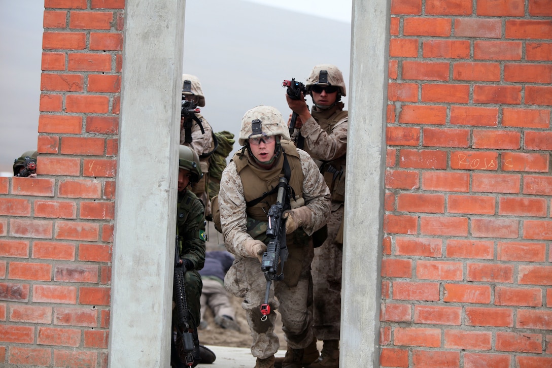 U.S. Marines with Special Purpose Marine Air-Ground Task Force 24 raid a building during multinational amphibious beach assault training exercise in Ancon, Peru on July 19, 2010 The unit was deployed in support of operation Partnership of the Americas/Southern Exchange, a combined amphibious exercise designed to enhance cooperative partnerships with maritime forces from Argentina, Mexico, Peru, Brazil, Uruguay, and Colombia.   (U.S. Marine Photo photo by Cpl Brian J. Slaght/Released)