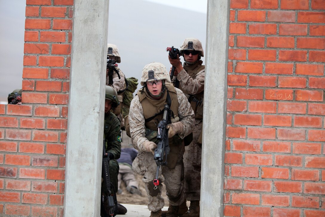 Marines with Special Purpose Marine Air-Ground Task Force 24 raid a building during a multinational amphibious beach assault training exercise in Ancon, Peru, July 19. The Marines were deployed in support of Partnership of the Americas/Southern Exchange, a combined amphibious exercise with maritime forces from Argentina, Mexico, Peru, Brazil, Uruguay and Colombia.