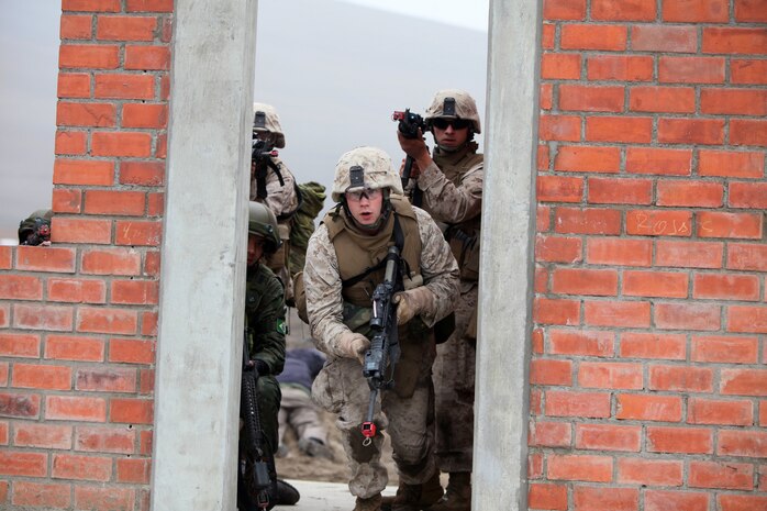 Marines with Special Purpose Marine Air-Ground Task Force 24 raid a building during a multinational amphibious beach assault training exercise in Ancon, Peru, July 19. The Marines were deployed in support of Partnership of the Americas/Southern Exchange, a combined amphibious exercise with maritime forces from Argentina, Mexico, Peru, Brazil, Uruguay and Colombia.