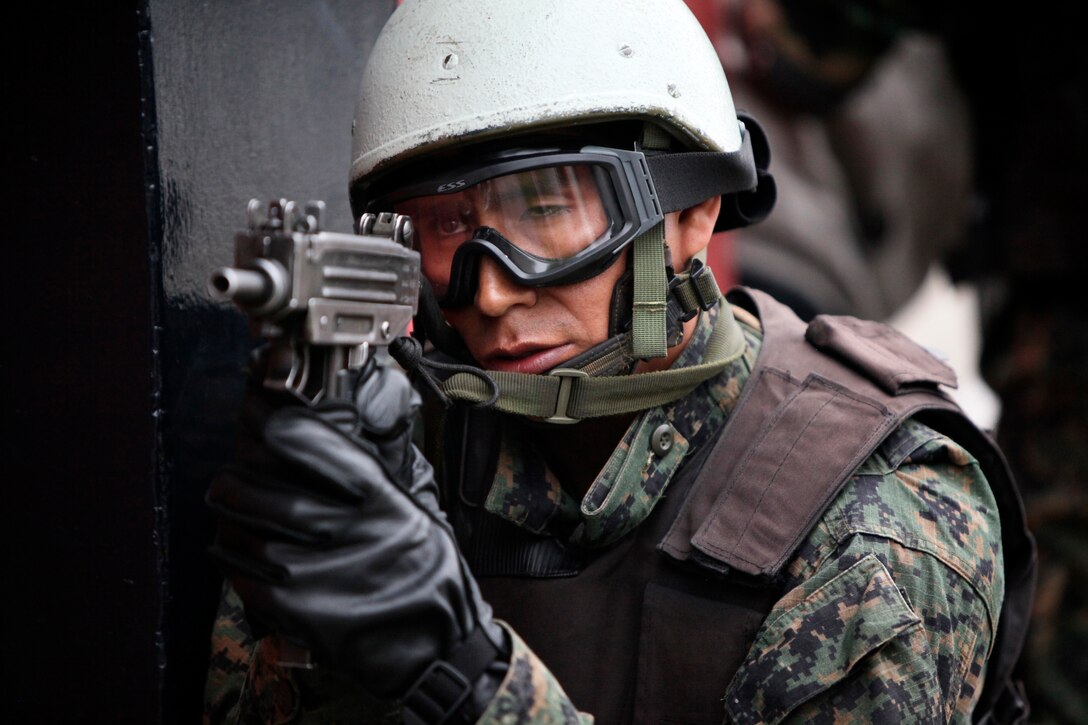 A Peruvian joint service special forces team member posts security while hostages are extracted onto a Marine Corps CH-46 Sea Knight helicopter during a multinational amphibious beach assault training exercise in Ancon, Peru, on July 19. Marines deployed in support of Partnership of the Americas/Southern Exchange, a combined amphibious exercise with maritime forces from Argentina, Mexico, Peru, Brazil, Uruguay and Colombia.