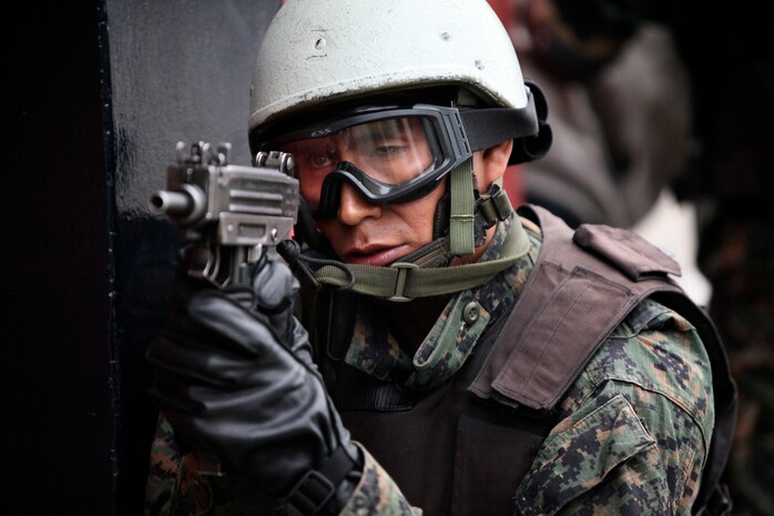 A Peruvian joint service special forces team member posts security while hostages are extracted onto a Marine Corps CH-46 Sea Knight helicopter during a multinational amphibious beach assault training exercise in Ancon, Peru, on July 19. Marines deployed in support of Partnership of the Americas/Southern Exchange, a combined amphibious exercise with maritime forces from Argentina, Mexico, Peru, Brazil, Uruguay and Colombia.