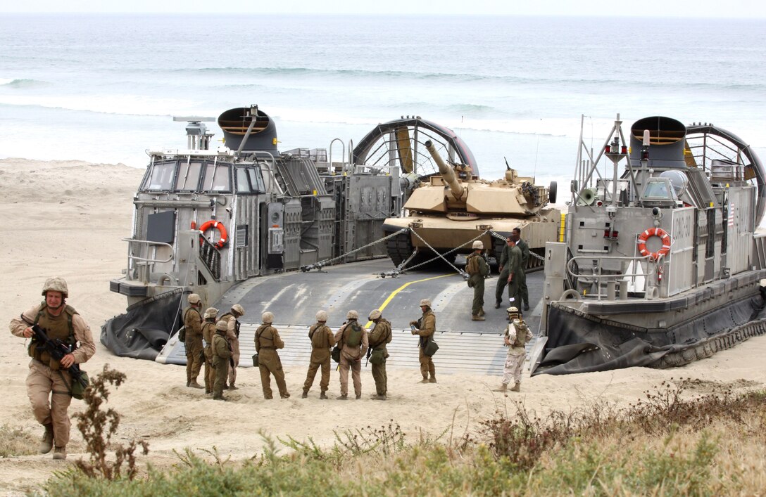 Reserve Marines with Alpha Company, 4th Tank Battalion, San Diego, prepare to board a Landing Craft Air Cushion during their annual training to simulate an amphibious land-and-assault at Camp Pendleton’s Red Beach, July 19. The service members transported weapon systems, equipment, cargo and personnel while performing assault scenarios utilizing the Marine Air/Ground Task Force.