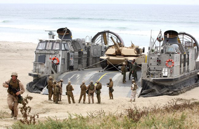 Reserve Marines with Alpha Company, 4th Tank Battalion, San Diego, prepare to board a Landing Craft Air Cushion during their annual training to simulate an amphibious land-and-assault at Camp Pendleton’s Red Beach, July 19. The service members transported weapon systems, equipment, cargo and personnel while performing assault scenarios utilizing the Marine Air/Ground Task Force.