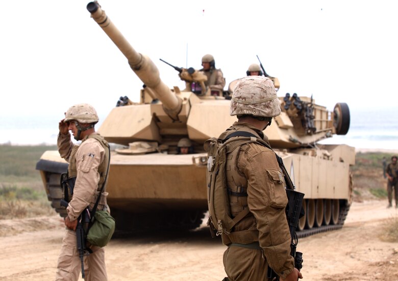 Reserve Marines with Alpha Company, 4th Tank Battalion, San Diego, guard and direct tanks during an amphibious land-and-assault scenario at Camp Pendleton’s Red Beach, July 19. Fourth Tank is making the most of their required annual training by learning how to apply their job to a war-like situation. More than 70 service members came together for this 10-day activity that began on the shore line of Red beach and is scheduled to end at the 41 Area, July 26.