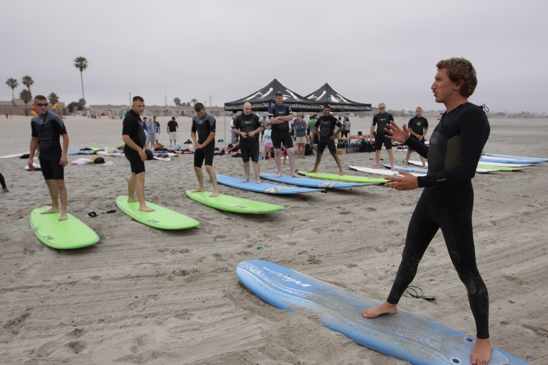 Marines with Wounded Warrior Battalion West take lessons from Mark Gerold (right), a volunteer instructor from the local community, during s special Ocean Therapy Program at Camp Del Mar Beach, Camp Pendleton, July 20. Ocean Therapy sessions are held on base each year, and provide Marines with an opportunity to learn surfing in an encouraging atmosphere, while focusing on the therapeutic benefits of the ocean.
