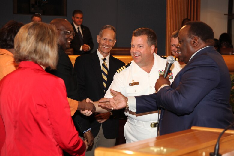 Navy Capt. Jeff Amick, the USS Iwo Jima commanding officer, shakes hands with Miami-Dade County Commissioners during a county commissioners meeting in Miami, Fla., July 20, 2010. Miami-Dade County Mayor Carlos Alvarez presented Amick and Lt. Col. Chris S. Richie, the commanding officer of Special-Purpose Marine Air-Ground Task Force Continuing Promise 2010, a key to Miami-Dade County for the efforts of CP10. More than 500 Special-Purpose MAGTF Marines and Sailors spent three days in Miami en route to the Caribbean, Central and South America during a four-month humanitarian assistance deployment.