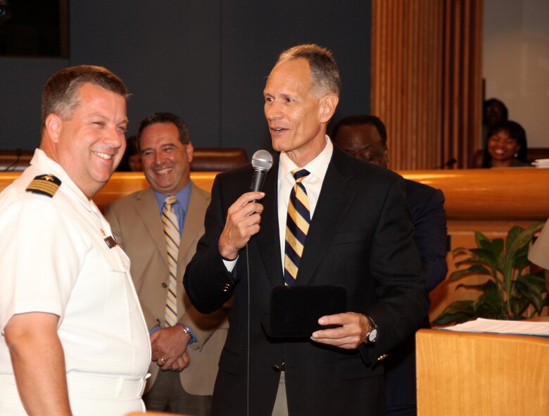 Miami-Dade County Mayor Carlos Alvarez presents Navy Capt. Jeff Amick, commanding officer of USS Iwo Jima, with a key to Miami-Dade County, July 20, 2010, during a county commissioners meeting in Miami, Fla. The key was given in recognition for the upcoming humanitarian assistance deployment in support of Continuing Promise 2010 to the Caribbean, Central and South America.
