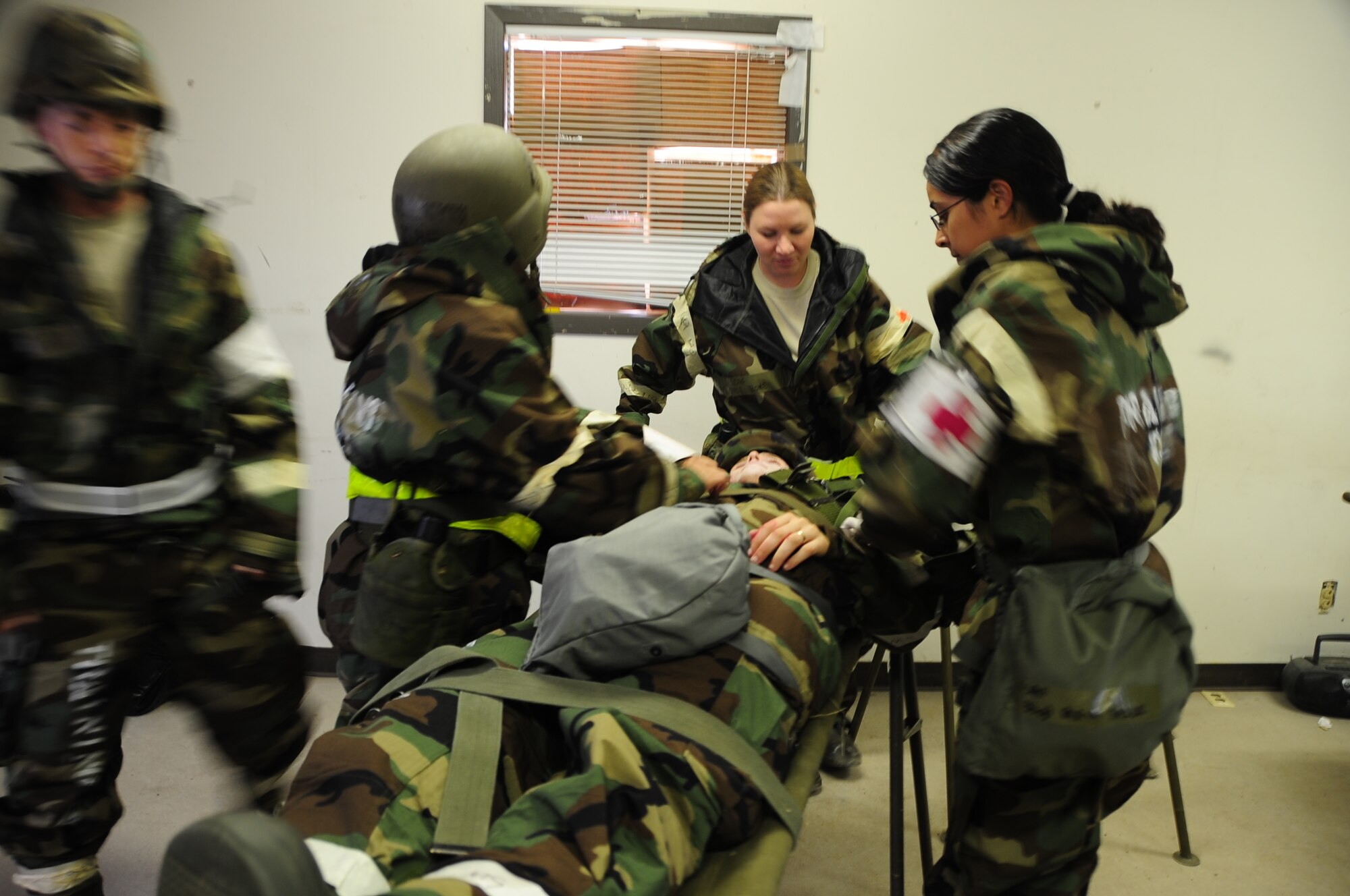 ELLSWORTH AIR FORCE BASE S.D. -- Airman 1st Class Corey Hook, 28th Bomb Wing photographer, lays on a stretcher with a simulated open abdominal wound while Airmen from the 28th Medical Operations Squadron conduct self-aid buddy care during a phase II operational readiness exercise, July 20.  Practicing SABC during a phase II ORE prepares Airmen for the possibility of using it in a combat zone. (U.S. Air Force photo/Airman 1st Class Anthony Sanchelli)