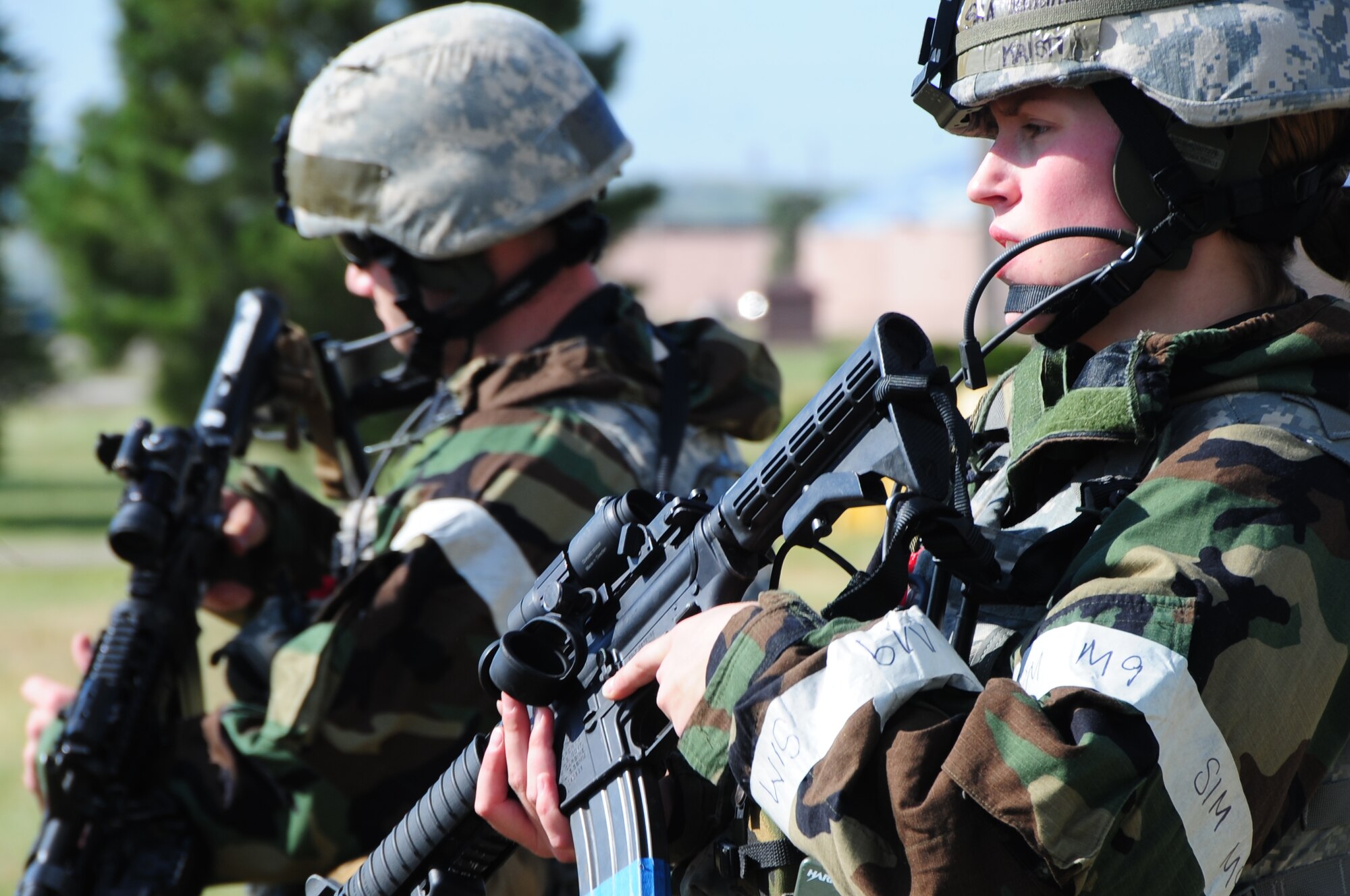 ELLSWORTH AIR FORCE BASE S.D. -- (Right to left) Senior Airman Kristi Terwilliger, 28th Security Forces Squadron controller, and Senior Airman Chadwick Richardson, 28 SFS patrol leader, patrol the simulated perimeter during a phase II operational readiness exercise, July 20.  Security Forces patrol the simulated deployed base, monitoring for potential threats within the scope of the exercise. (U.S. Air Force photo/Airman 1st Class Anthony Sanchelli)