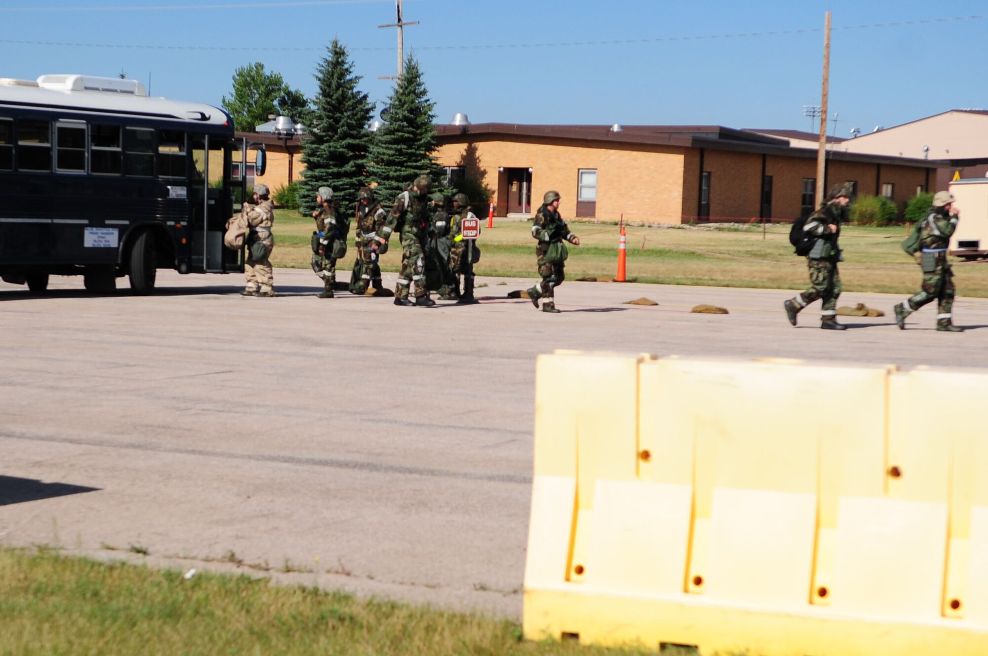 ELLSWORTH AIR FORCE BASE, S.D. – Airmen depart a 28th Logistics Readiness Squadron bus during a phase II operational readiness exercise, July 20. Buses have a set schedule to provide transportation for all Airmen, during the exercise. (U.S. Air Force photo/Airman 1st Class Corey Hook)