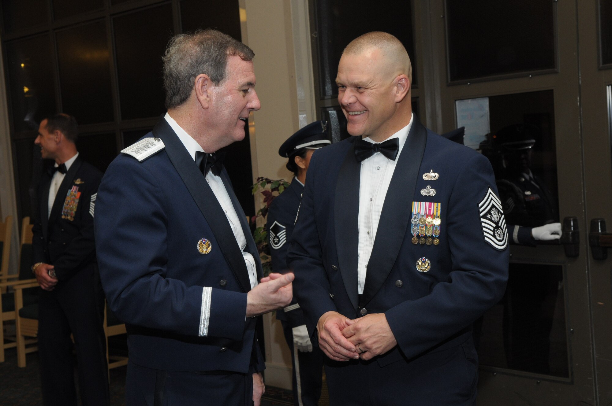 Gen. Stephen R. Lorenz, Commander, Air Education and Training Command, talks with Chief Master Sgt. James A. Roy, Chief Master Sgt. of the Air Force, after his induction into the Order of the Sword, at the Gateway Club on Lackland AFB, July 16. More than 300 Airmen from across AETC gathered to witness General Lorenz’s induction. The Order of the Sword is the highest honor and tribute noncommissioned officers can bestow upon an individual. (U.S. Air Force photo/Joel Martinez)