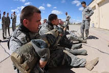 MINOT AIR FORCE BASE, N.D. -- Airmen in tactical response force training use a log while participating in physical training activities to encourage and show the value of working as a team here July 14. Everyone who tries out for the tactical response force team must undergo a series of training designed to push them beyond their physical limits and to evaluate how well they work under a great deal of pressure. (U.S. Air Force photo by Airman 1st Class Aaron-Forrest Wainwright)