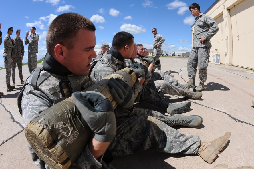 MINOT AIR FORCE BASE, N.D. -- Airmen in tactical response force training use a log while participating in physical training activities to encourage and show the value of working as a team here July 14. Everyone who tries out for the tactical response force team must undergo a series of training designed to push them beyond their physical limits and to evaluate how well they work under a great deal of pressure. (U.S. Air Force photo by Airman 1st Class Aaron-Forrest Wainwright)