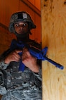 MINOT AIR FORCE BASE, N.D. -- Airman 1st Class Isai Reyes, 791st Missile Security Forces Squadron set guard, provides security during a room clearing training exercise for his tactical response force team here July 14. Everyone who tries out for the tactical response force team must undergo a series of training designed to push them beyond their physical limits and to evaluate how well they work under a great deal of pressure. (U.S. Air Force photo by Airman 1st Class Aaron-Forrest Wainwright)