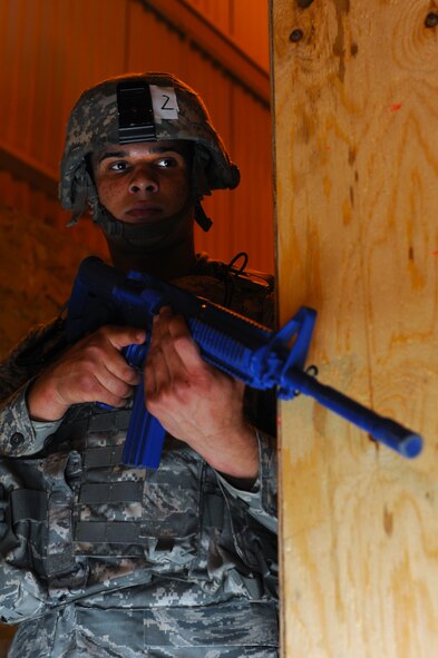 MINOT AIR FORCE BASE, N.D. -- Airman 1st Class Isai Reyes, 791st Missile Security Forces Squadron set guard, provides security during a room clearing training exercise for his tactical response force team here July 14. Everyone who tries out for the tactical response force team must undergo a series of training designed to push them beyond their physical limits and to evaluate how well they work under a great deal of pressure. (U.S. Air Force photo by Airman 1st Class Aaron-Forrest Wainwright)