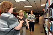 OFFUTT AIR FORCE BASE, Neb. - Rebecca Sims, library director with the 55th Force Support Squadron, speaks to Kim Spears, wife of 12th Air Force commander Lt. Gen. Glenn Spears, and Laura Shanahan, wife of 55th Wing commander Brig. Gen. John N.T. Shanahan, about the different services provided by the Offutt library July 14. This was General Spears' first official visit to Offutt and he was briefed on mission capabilities, saw new buildings, met with young Airmen and hosted a wing-wide all call. U.S. Air Force photo by Charles Haymond