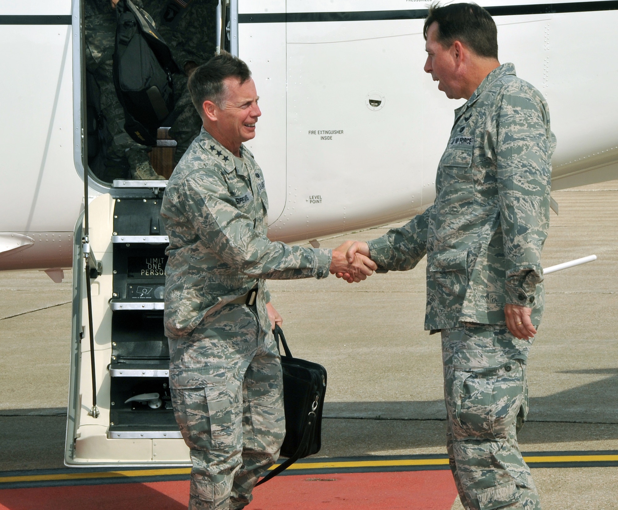 OFFUTT AIR FORCE BASE, Neb. - Brig. Gen. John N.T. Shanahan, 55th Wing commander, greets Lt. Gen. Glenn Spears, 12th Air Force commander, as he arrives at Offutt July 13 for his first official visit to the base. During his visit, General Spears was briefed on mission capabilities, saw new buildings and met with young Airmen. He also held an all call where he discussed topics currently facing the Air Force and its members such as new physical fitness standards and emerging technology. U.S. Air Force photo by Jeff W. Gates. 