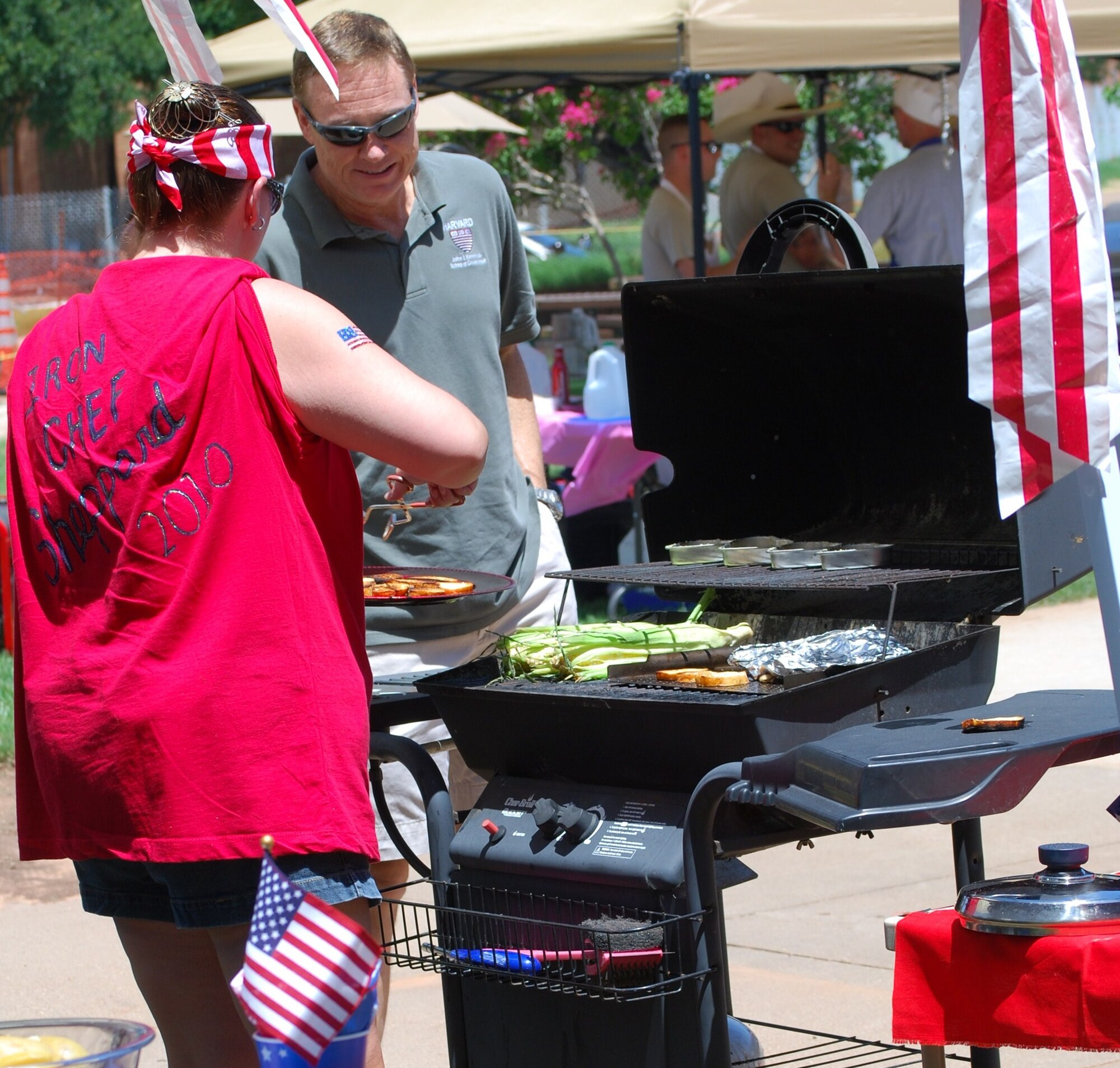Stacey Dupre (left) gives Brig. Gen. Darryl Burke (right), 82nd Training Wing commander, a preview of some of the foods that the Patriotic Pals team will grill and present to judges at the inaugural Sheppard Iron Chef competition at the Community Center at Sheppard Air Force Base, Texas, July 17.  The inaugural Sheppard Iron Chef competition featured eight teams that had one hour to prepare an appetizer, main dish and dessert to be judged for presentation, taste and other criteria.  (U.S. Air Force photo/Tech. Sgt. Vernon Cunningham)