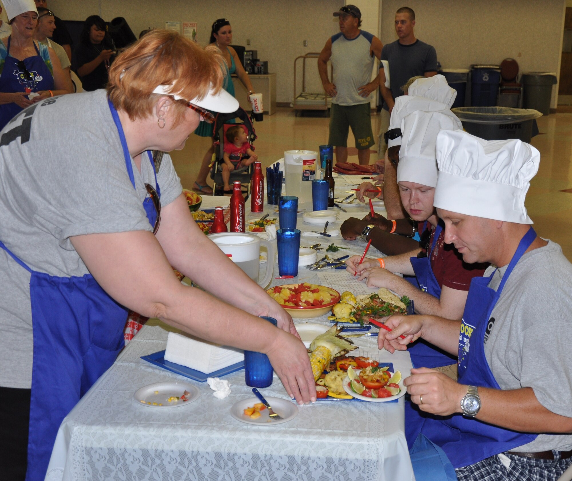 Lt. Col. Erik Bovasso (right) determines a score for the presentation of an entry at the inaugural Sheppard Iron Chef competition in the Community Center at Sheppard Air Force Base, Texas, July 17. Colonel Bovasso, 82nd Force Support Squadron commander, was one of five judges who graded the eight teams’ grilled entries for presentation, taste and other criteria.  (U.S. Air Force photo/Tech. Sgt. Vernon Cunningham)